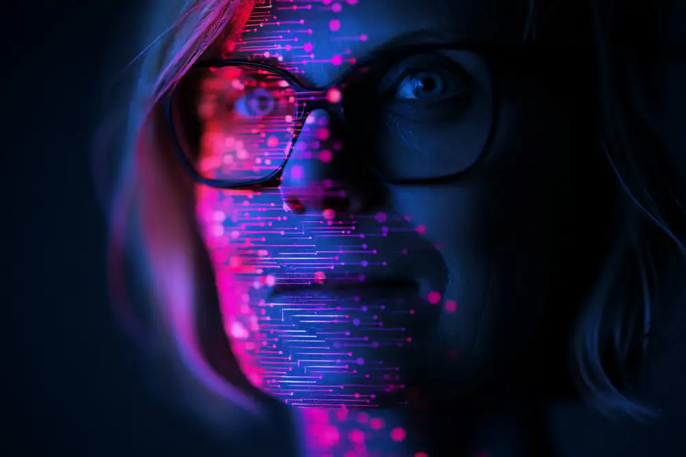 Frauengesicht mit Brille, überlagert von pink-blauer Datenprojektion.